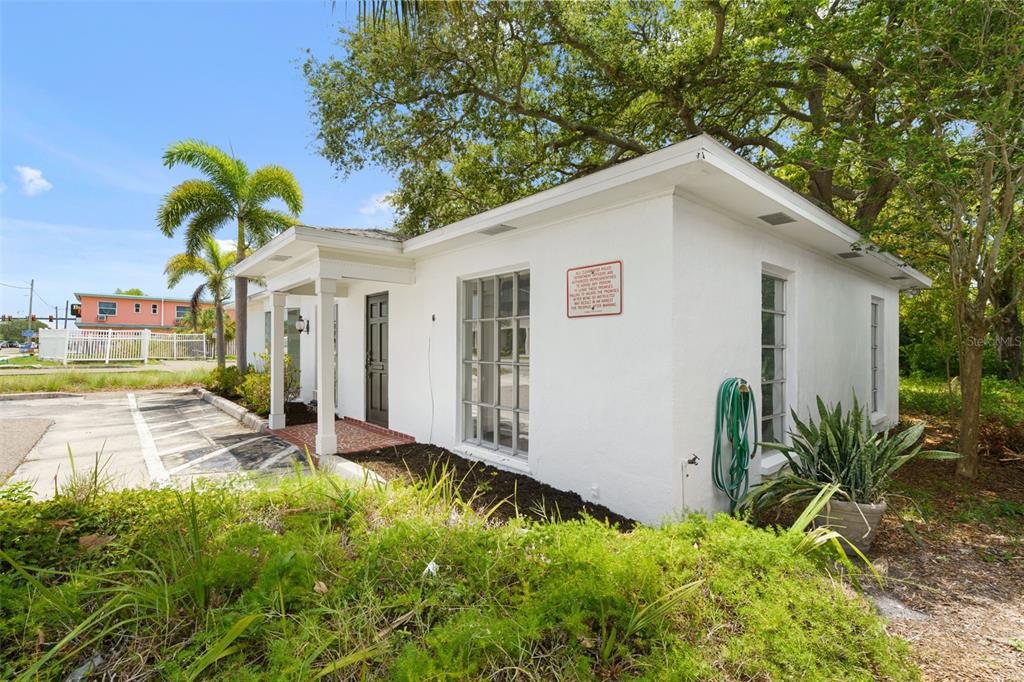 A white, single-story building with a covered entryway and a parking lot in front — 1455 COURT STREET, CLEARWATER, FL