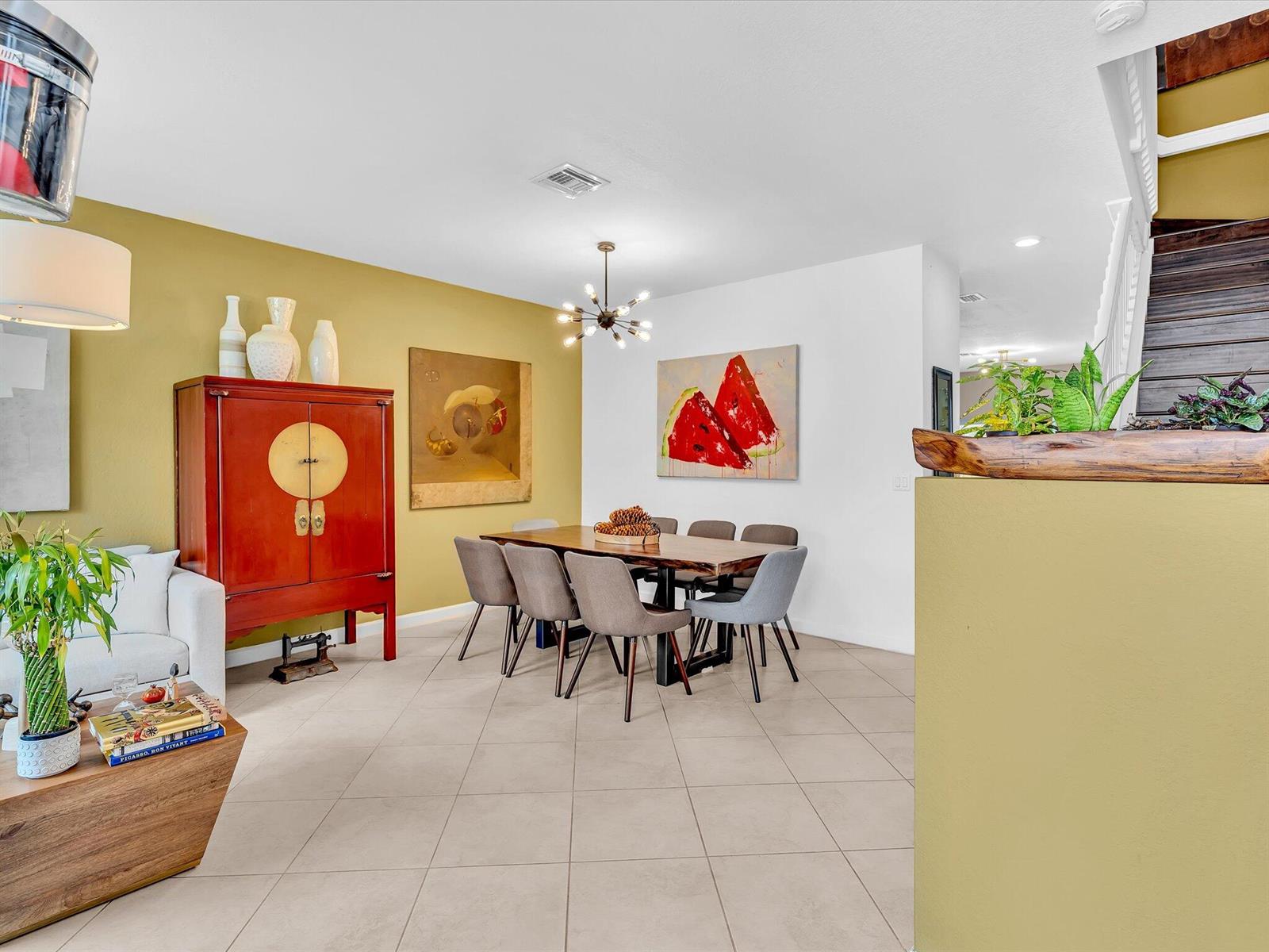 A dining area features a wooden table, grey chairs, a red cabinet, and watermelon artwork — 5331 Ashley River Road, West Palm Beach FL 33417, WEST PALM BEACH, FL