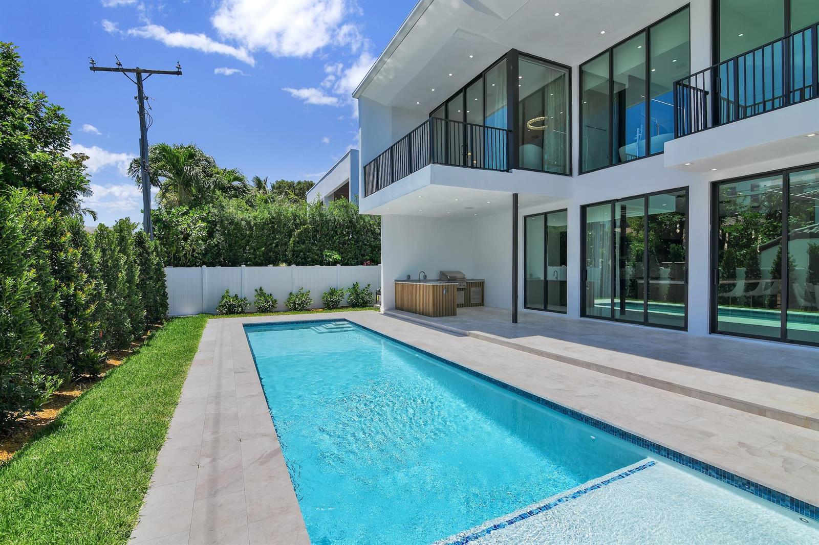 A modern two-story house with a swimming pool, patio, and outdoor kitchen in the backyard — 344 NE 2nd Street, Boca Raton FL 33432, BOCA RATON, FL