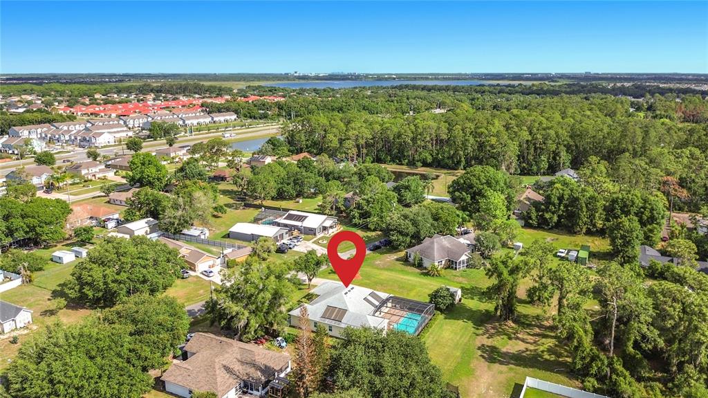 An aerial view shows a residential house with a swimming pool and solar panels — 2155 BARRATT COURT, ST CLOUD, FL
