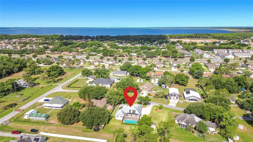 An aerial view shows a residential house with a swimming pool and a red pin — 2155 BARRATT COURT, ST CLOUD, FL