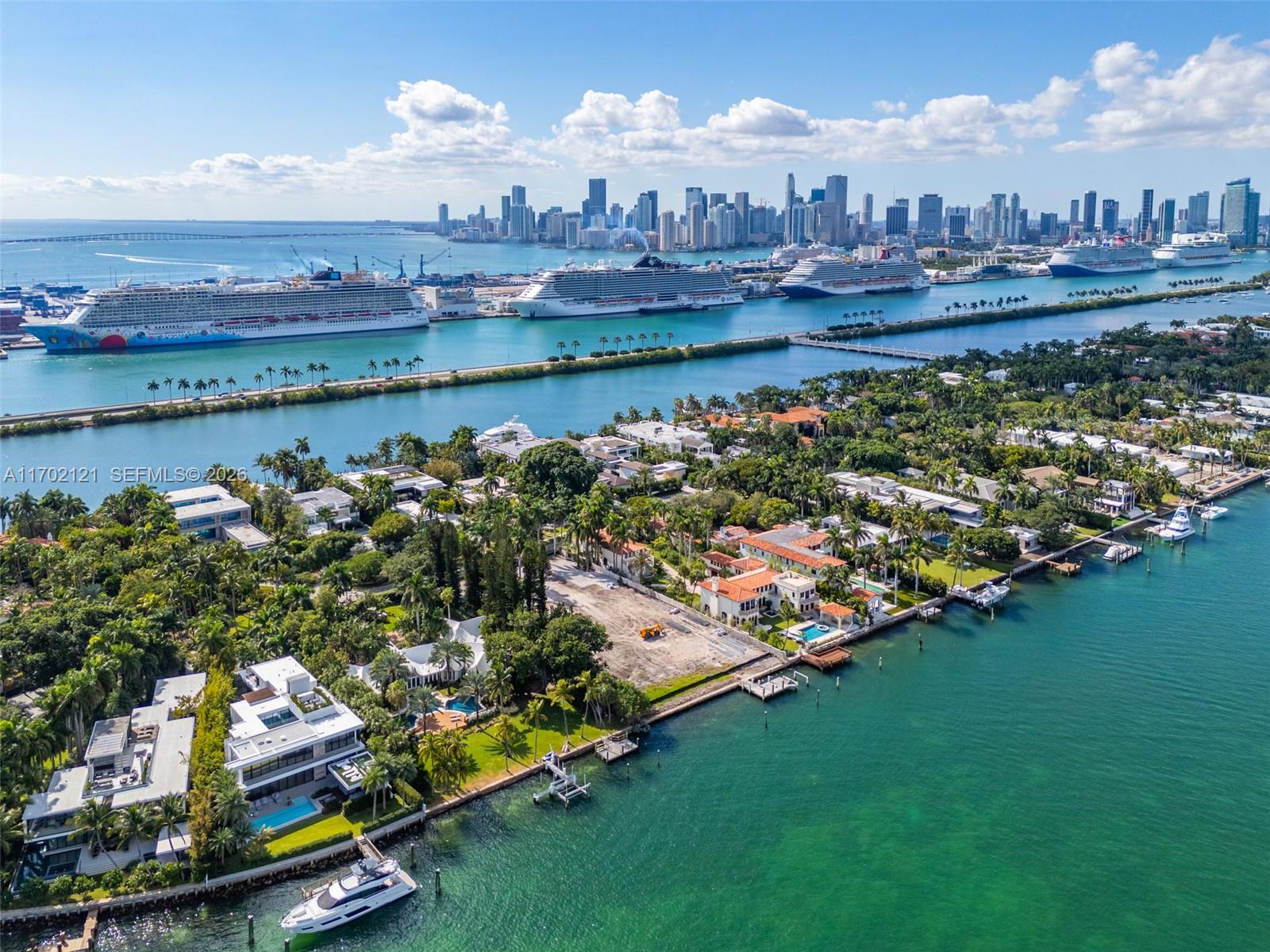 An aerial view shows waterfront luxury homes with private docks near a cruise ship port — 49 Palm Ave, Miami Beach FL 33139, MIAMI BEACH, FL