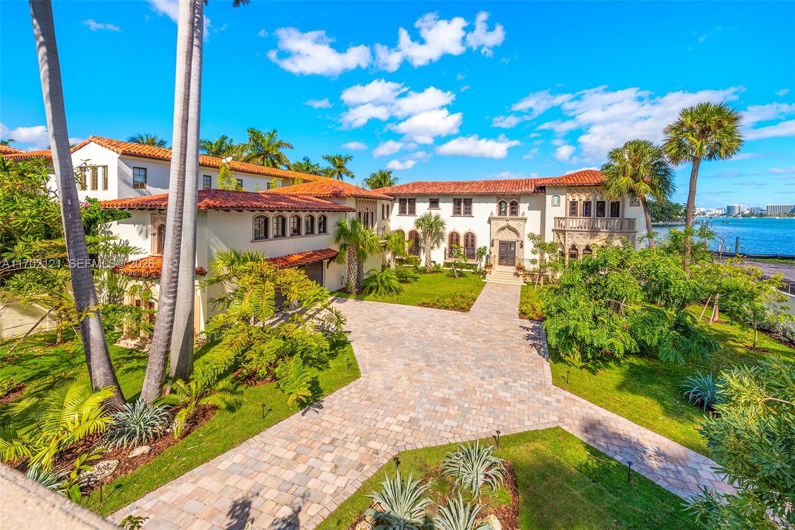 An aerial view of a Mediterranean-style mansion with a tiled roof and a paved driveway — 49 Palm Ave, Miami Beach FL 33139, MIAMI BEACH, FL