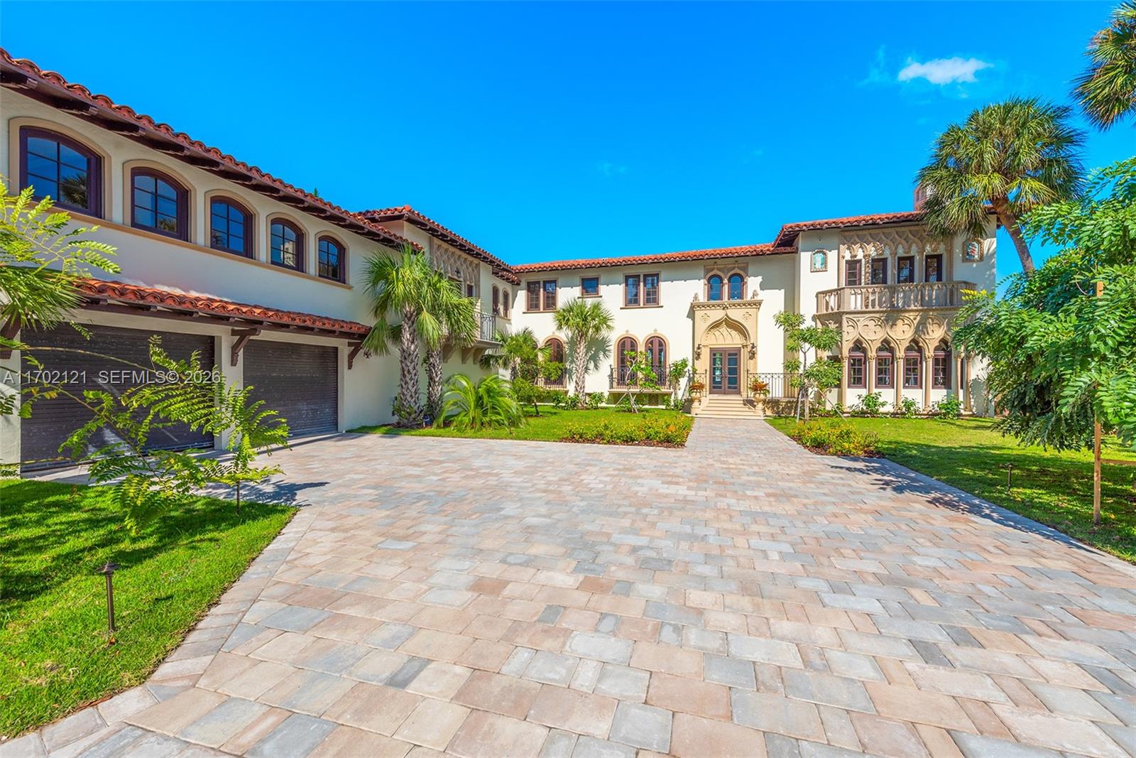 A large Mediterranean-style house with a tiled roof, arched windows, and a paved driveway — 49 Palm Ave, Miami Beach FL 33139, MIAMI BEACH, FL