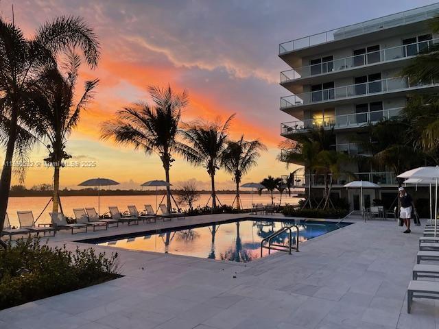 A swimming pool sits on a patio beside a multi-story building at sunset — 2560 S Ocean Blvd # 312, Palm Beach FL 33480, PALM BEACH, FL