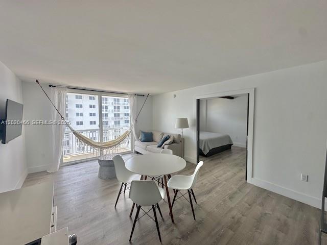 A living area features a dining table, a hammock, and a sliding door to a bedroom — 401 Ocean Dr # 910, Miami Beach FL 33139, MIAMI BEACH, FL