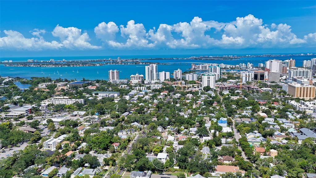 An aerial view shows a residential neighborhood with a white house circled in the foreground — 543 COLUMBIA COURT, SARASOTA, FL