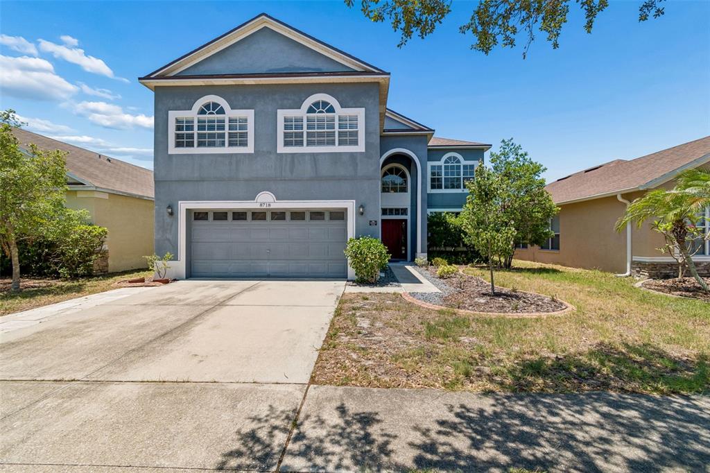 A two-story blue house with a two-car garage and a front walkway — 8718 SANDY PLAINS DRIVE, RIVERVIEW, FL