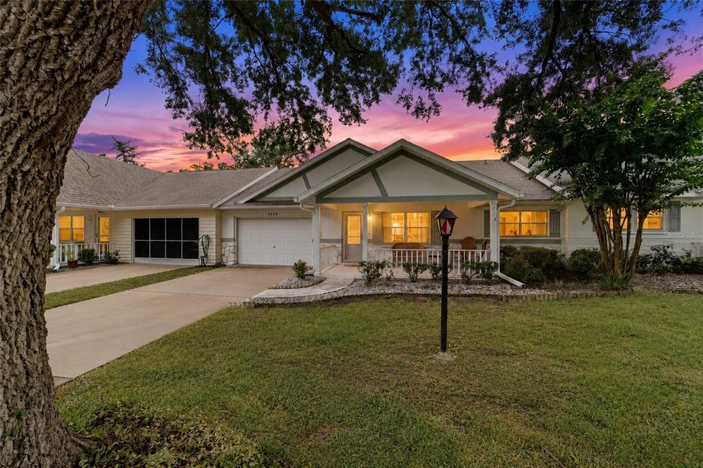 A single-story house with a white garage, a covered front porch, and a grassy lawn — 8526 SW 91ST STREET UNIT D, OCALA, FL