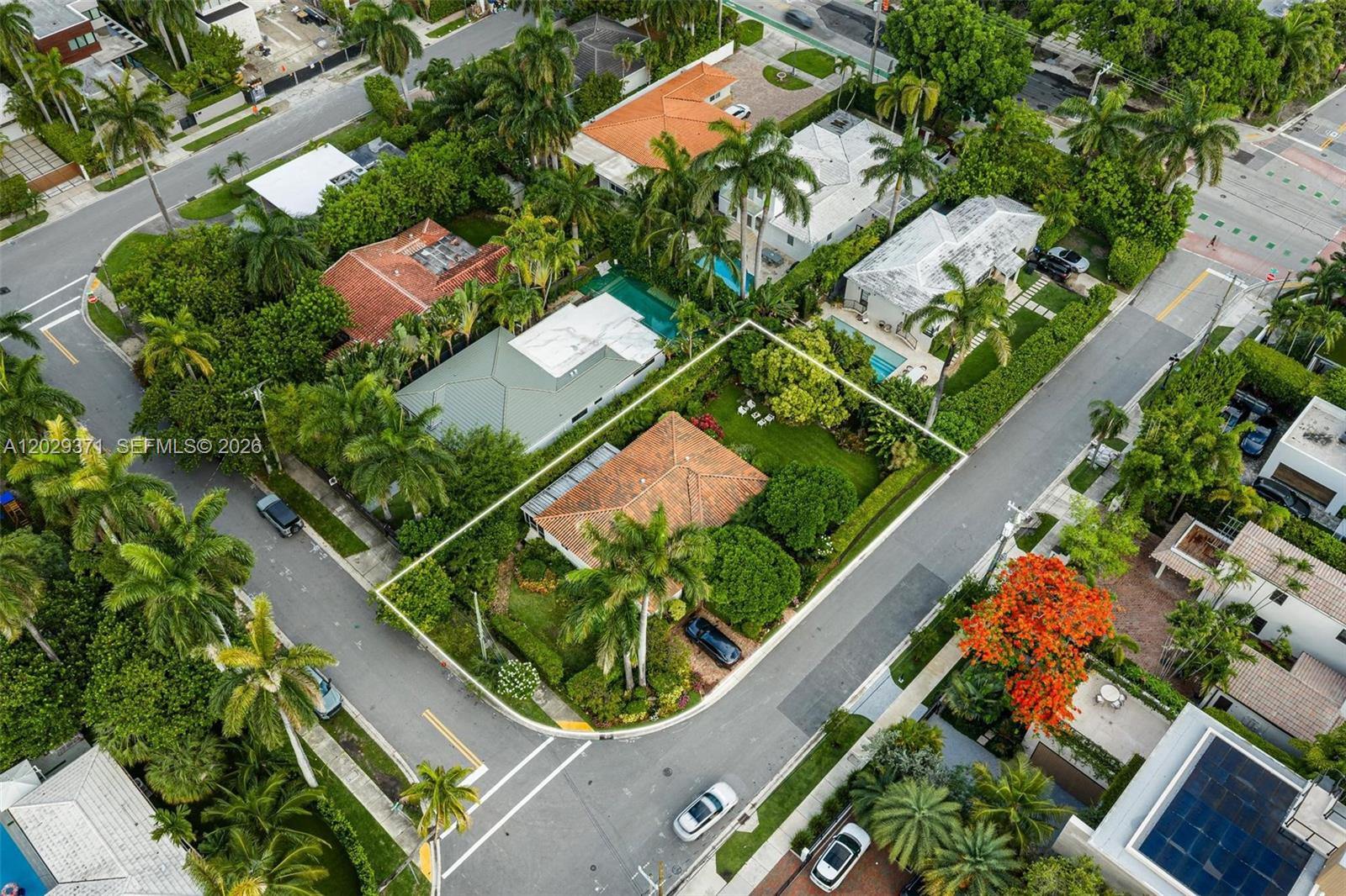 An aerial view shows a single-story house with a tiled roof and a corner lot — 455 W Dilido Dr, Miami Beach FL 33139, MIAMI BEACH, FL