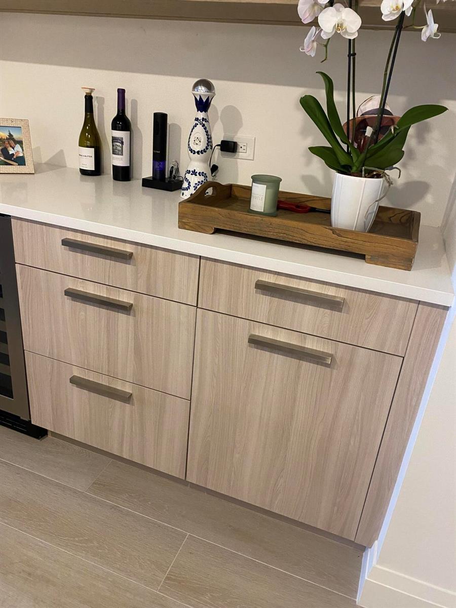 A kitchen bar area features light wood cabinets, a white countertop, and decorative items — 1021 Hillsboro Mile # G6, Hillsboro Beach FL 33064, HILLSBORO BEACH, FL