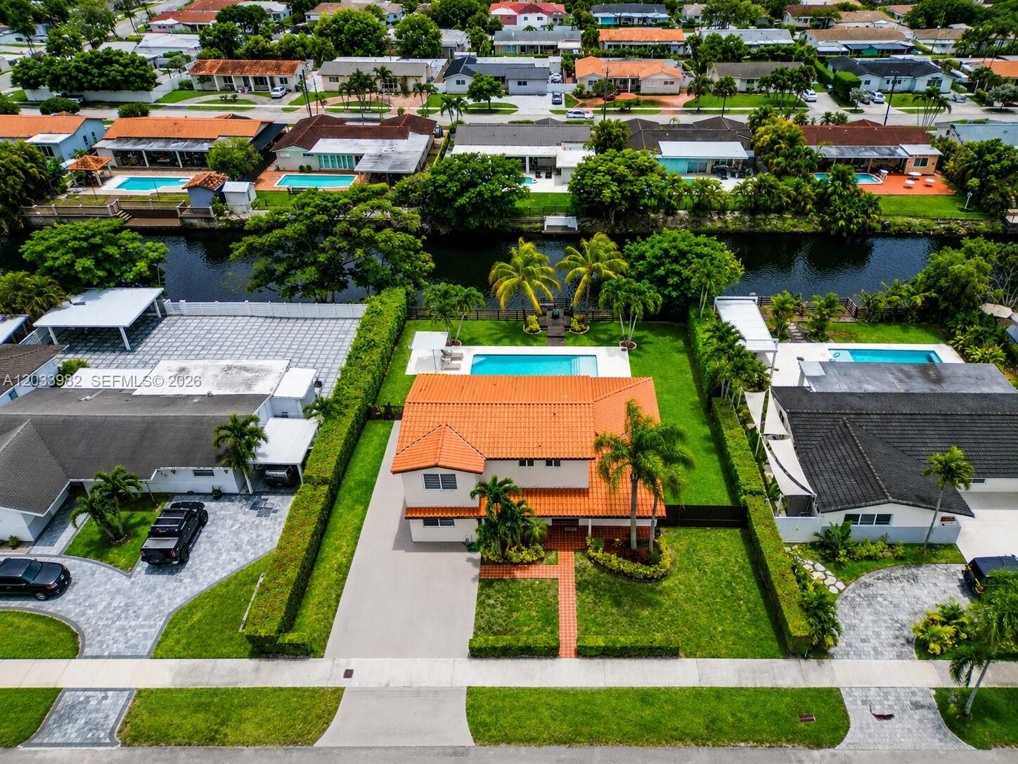An aerial view shows a two-story house with a red tile roof and backyard pool — 9780 SW 19th St, Miami FL 33165, MIAMI, FL