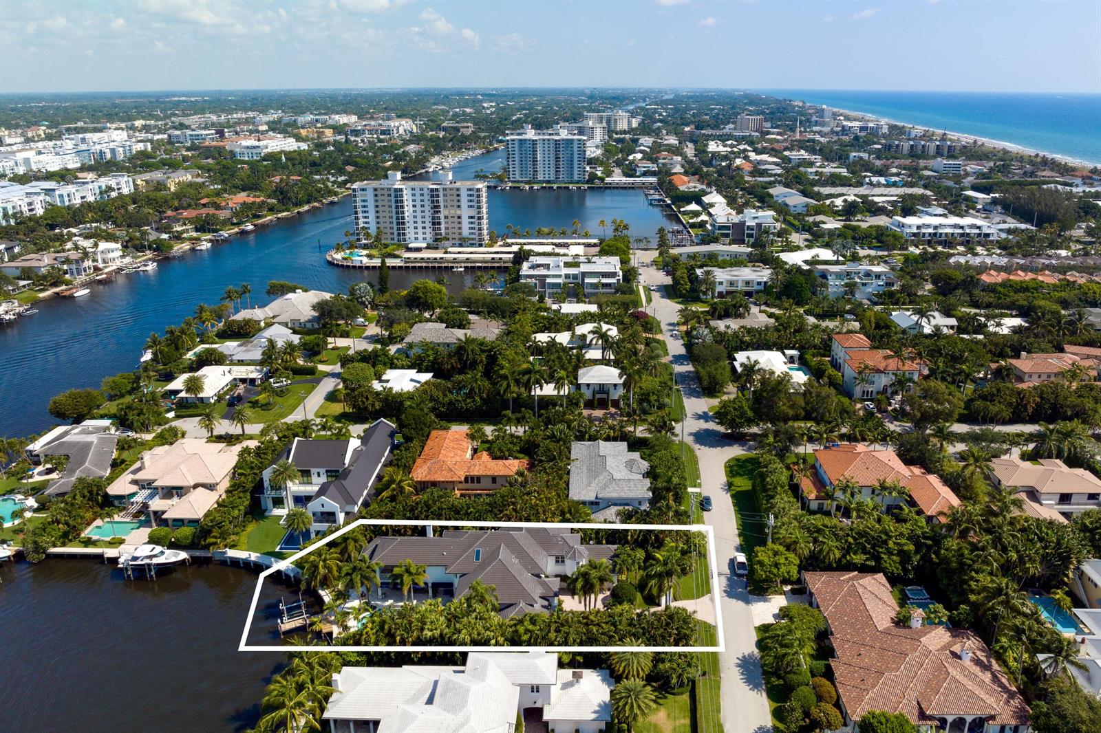 An aerial view of a waterfront house with a pool and dock in a neighborhood — 616 Seasage Drive, Delray Beach FL 33483, DELRAY BEACH, FL