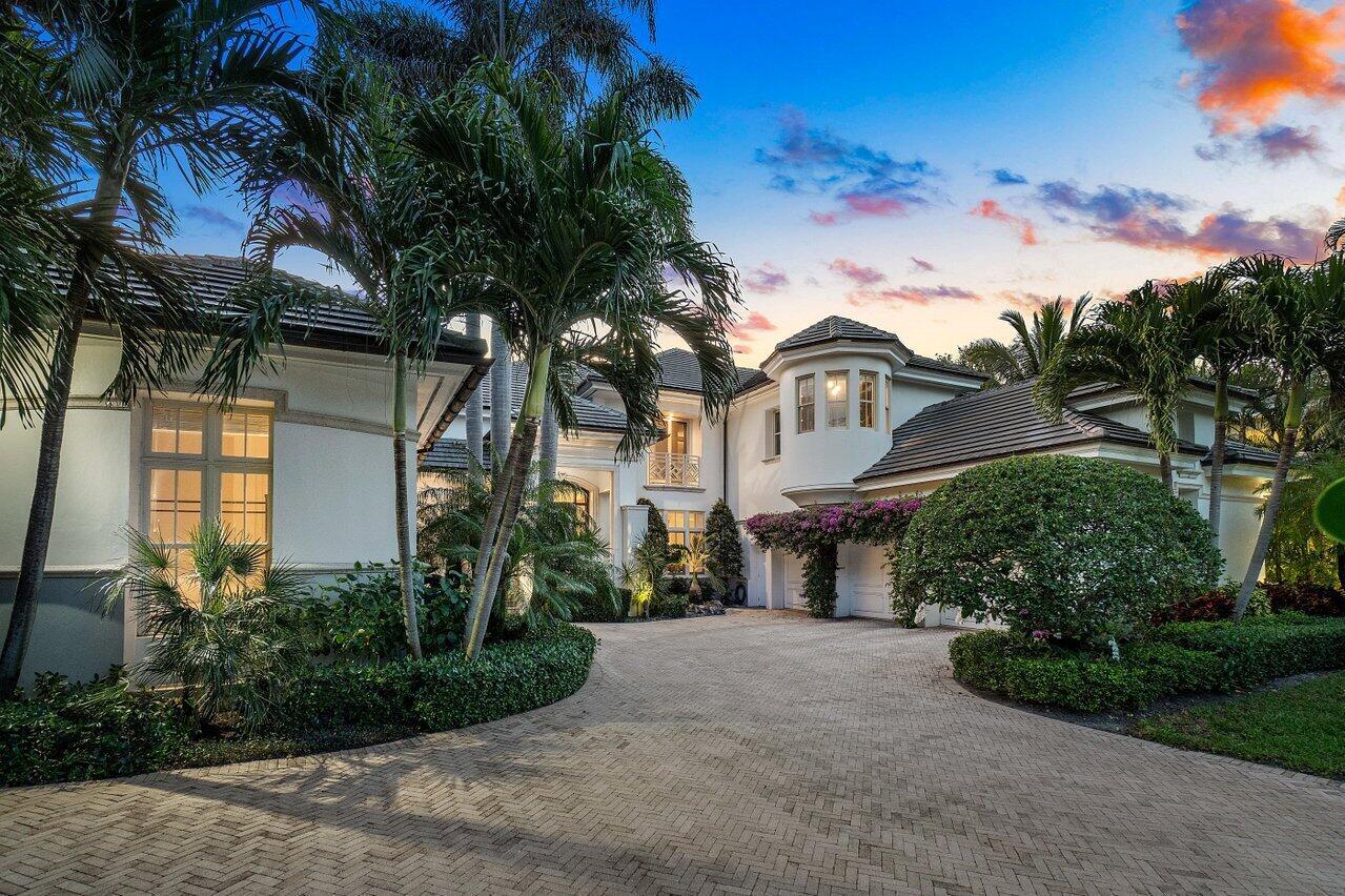 A large two-story house with a paved driveway, palm trees, and a landscaped front yard — 616 Seasage Drive, Delray Beach FL 33483, DELRAY BEACH, FL