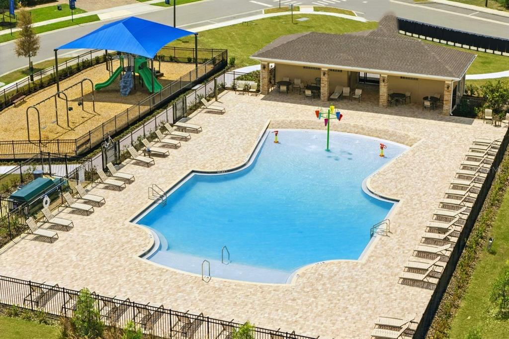 An aerial view of a community swimming pool, playground, and covered patio area — 1113 MAJESTY PALM CIRCLE, DELAND, FL