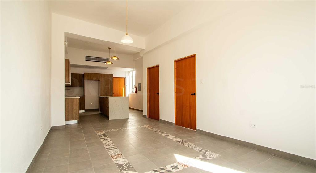 An open-concept living area features a kitchen with wood cabinets and a tiled floor — 319 RECINTO SUR STREET UNIT 6, SAN JUAN, PR