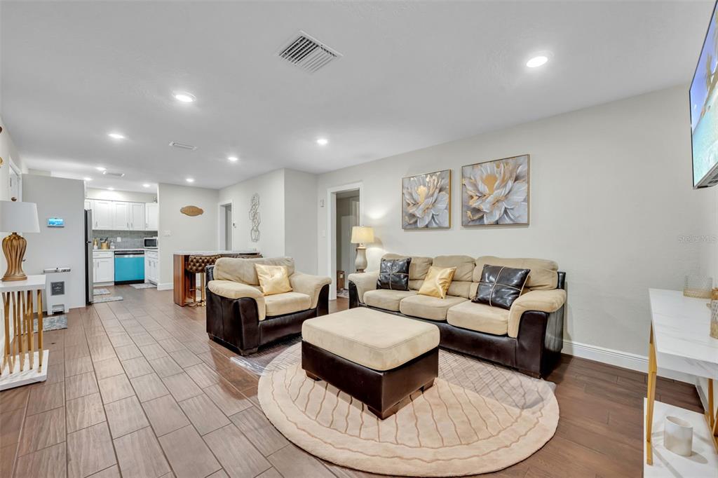 The exterior of a house features a white front door, gray stucco walls, and pavers — 1221 ELINORE DRIVE, ORLANDO, FL