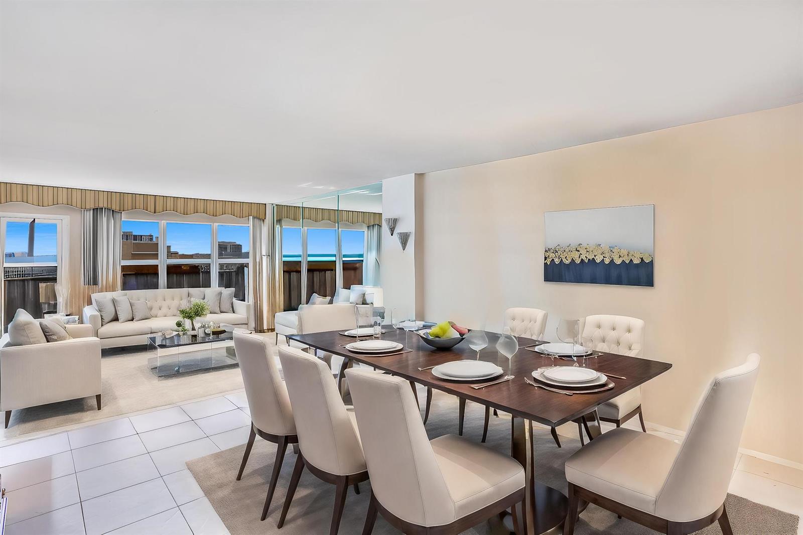 A white kitchen features black countertops, white cabinetry, and a vaulted ceiling with gold trim — 405 N Ocean Boulevard # 1704, Pompano Beach FL 33062, POMPANO BEACH, FL