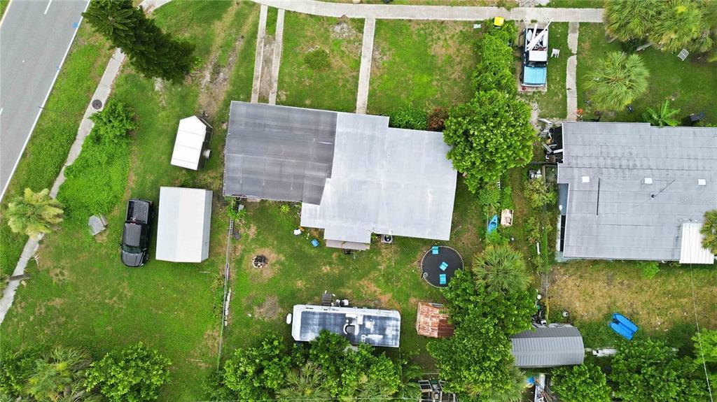An aerial view shows a house with a flat roof, a yard, and several outbuildings — 21378 PERCY AVENUE, PORT CHARLOTTE, FL