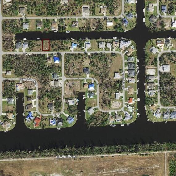 An aerial map view shows a vacant waterfront lot outlined in red within a residential neighborhood — 15108 LYNEBURG AVENUE, PORT CHARLOTTE, FL
