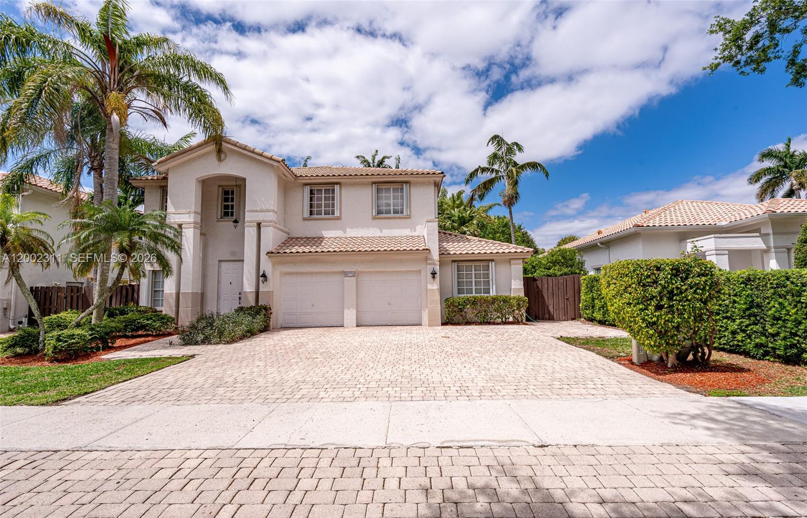 A two-story stucco house with a tiled roof, two-car garage, and a paved driveway — 6772 NW 111th Ave, Doral FL 33178, DORAL, FL
