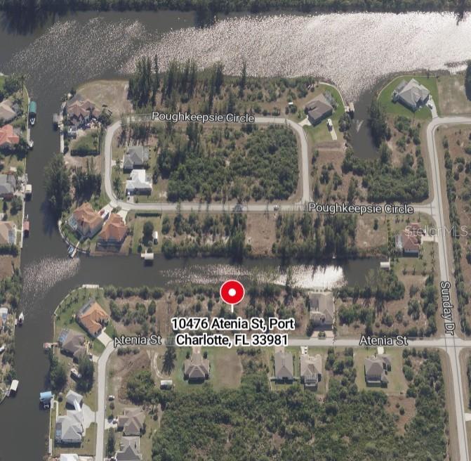 This is an aerial map view of a residential lot located along a canal — 10476 ATENIA STREET, PORT CHARLOTTE, FL