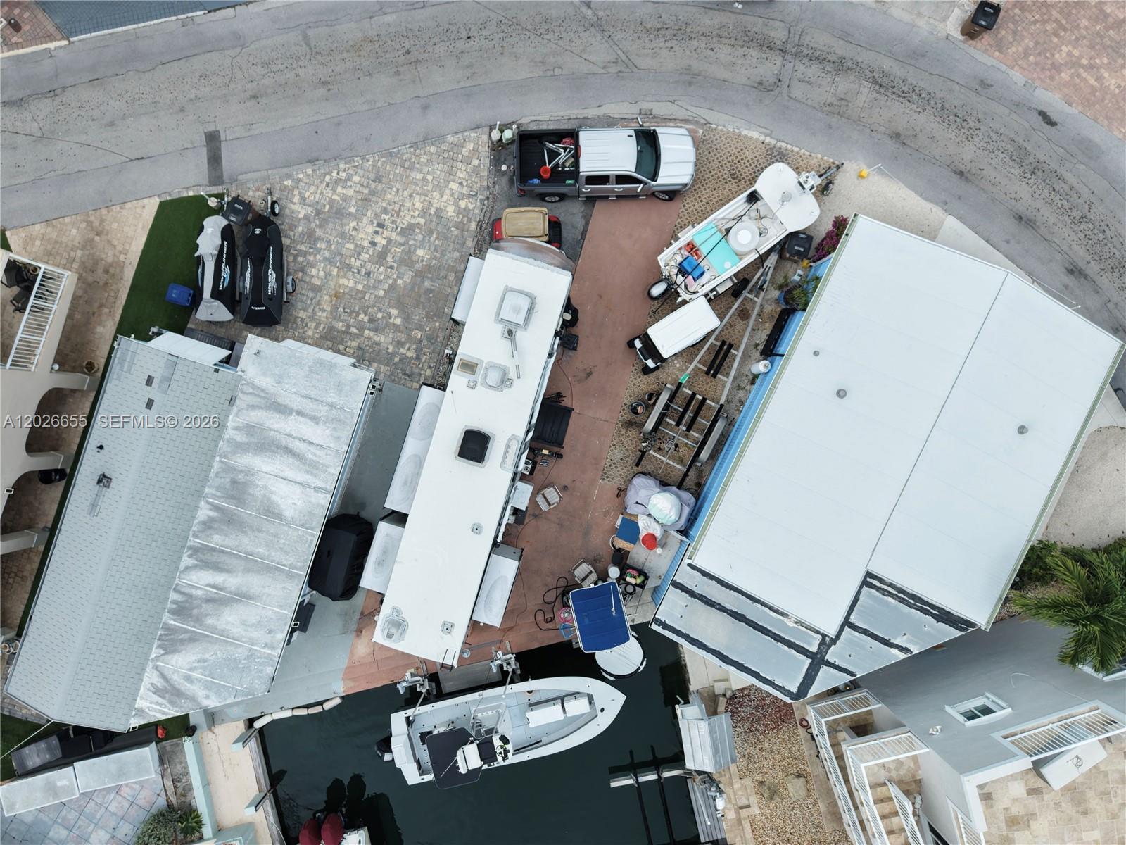 An aerial view shows a canal lined with houses and boats leading to the ocean — 65821 Overseas Hwy #93, Long Key FL 33001, LONG KEY, FL