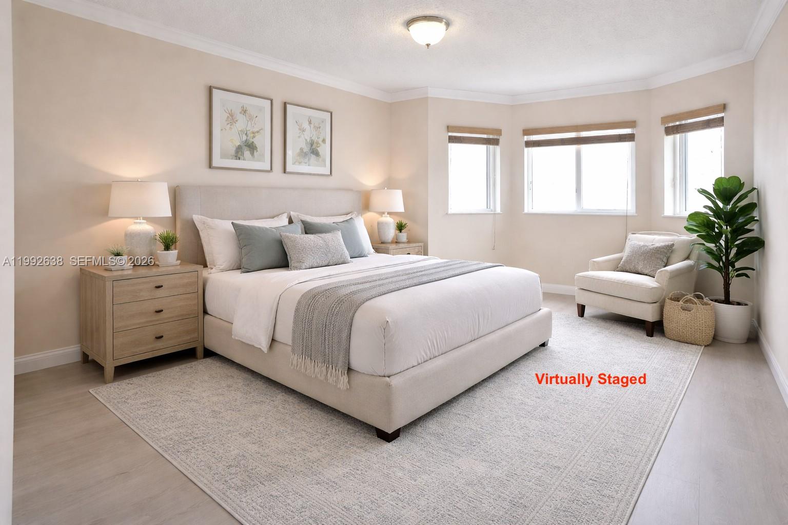 A virtually staged bedroom features a bed, two nightstands, an armchair, and a potted plant — 8421 SW 124th Ave # 101, Miami FL 33183, MIAMI, FL