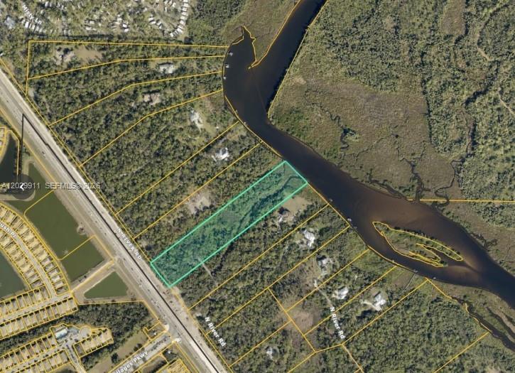 This aerial map shows a rectangular parcel of land highlighted in green along a river — 770 N River Rd, Venice FL 34293, VENICE, FL