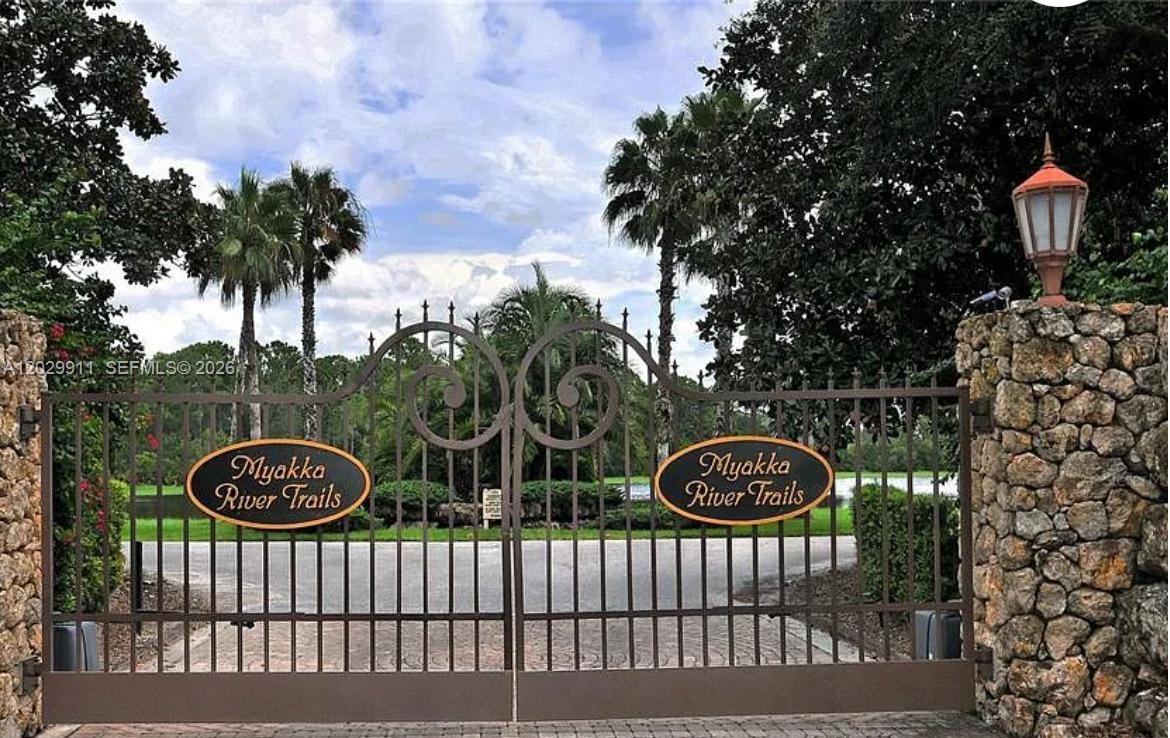 A gated entrance with stone pillars and metal gates labeled Myakka River Trails — 770 N River Rd, Venice FL 34293, VENICE, FL