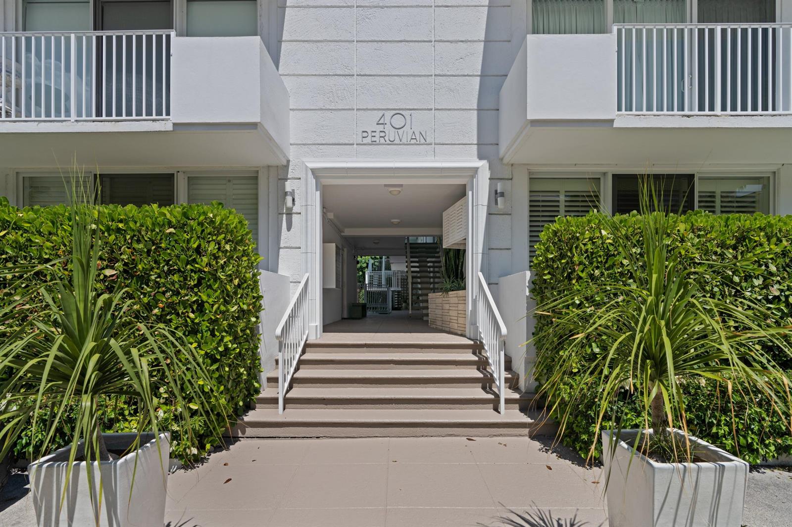 The exterior of a white building features a central entrance with stairs and potted plants — 401 Peruvian Avenue # 3020, Palm Beach FL 33480, PALM BEACH, FL