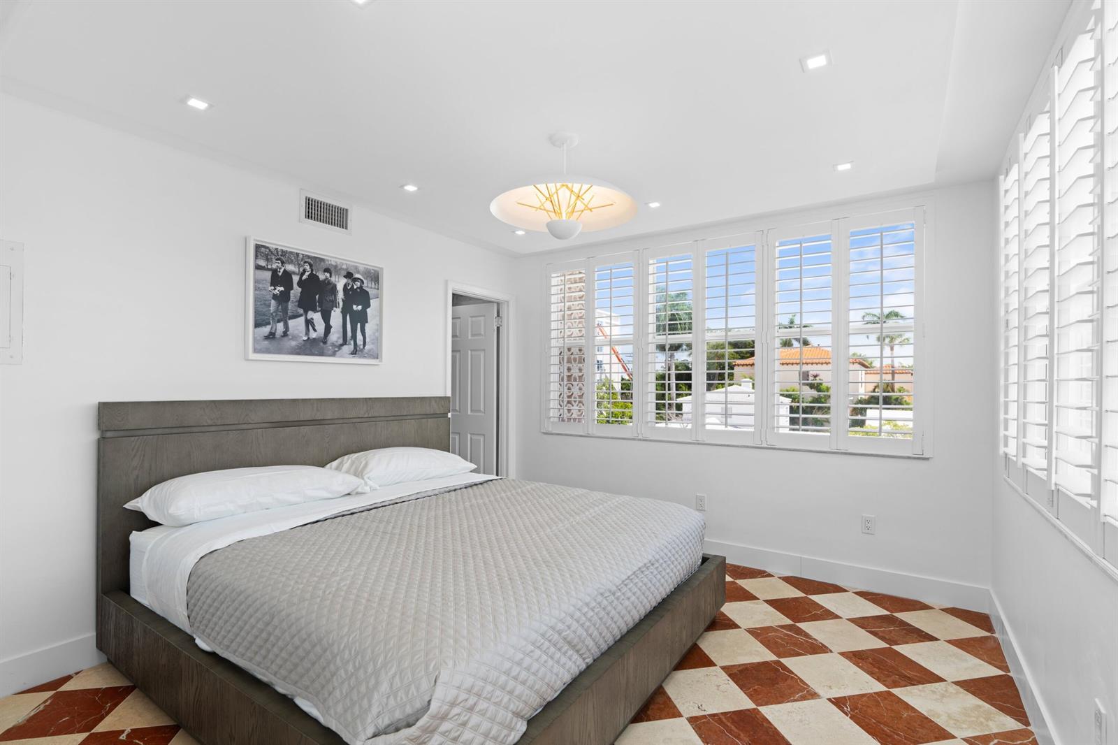 A bedroom with a gray bed, white walls, and a red and white checkered floor — 401 Peruvian Avenue # 3020, Palm Beach FL 33480, PALM BEACH, FL
