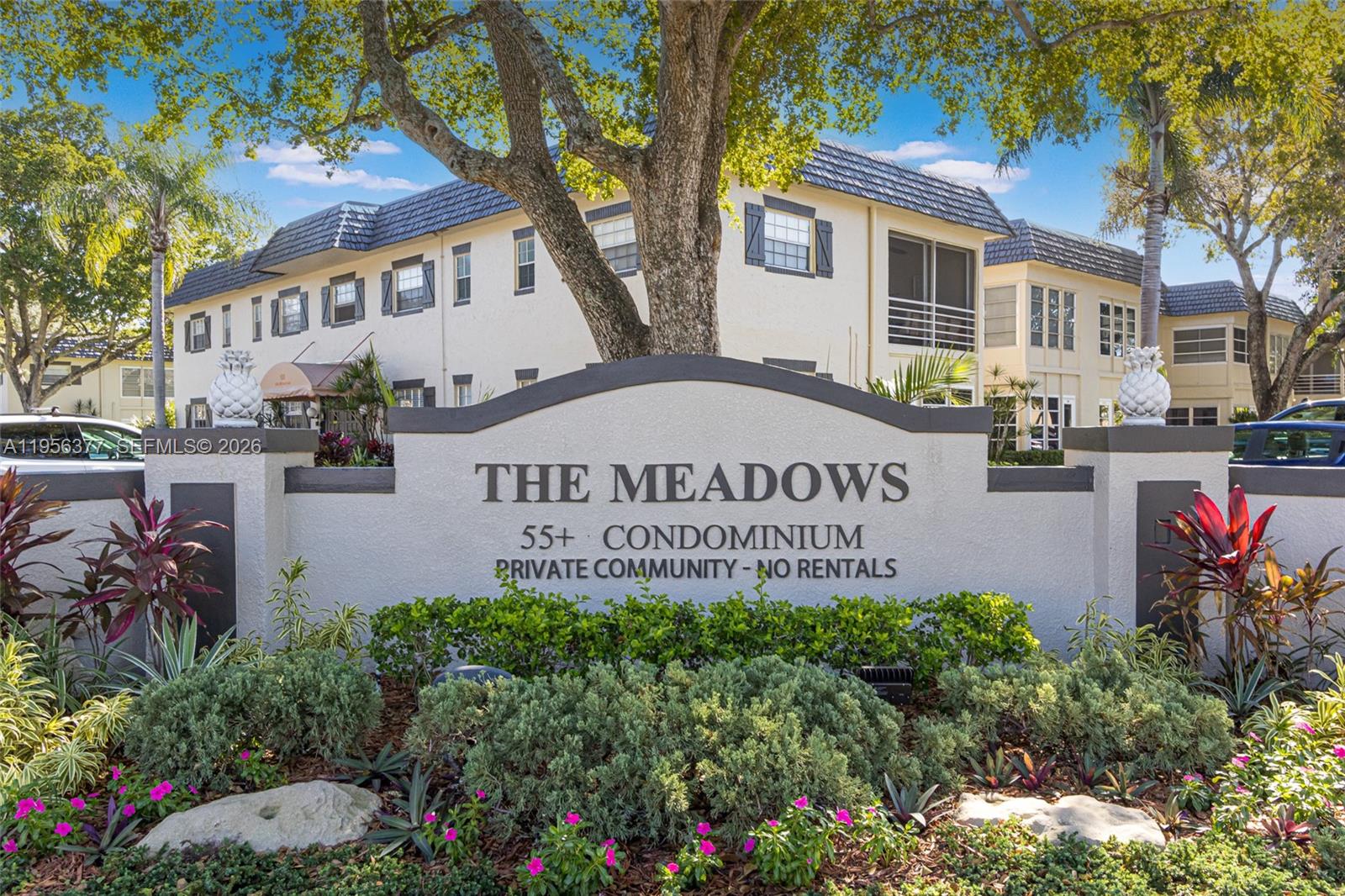 A sign for The Meadows 55+ condominium community stands in front of a multi-story building — 5661 SW 2nd Ct # 101, Margate FL 33068, MARGATE, FL