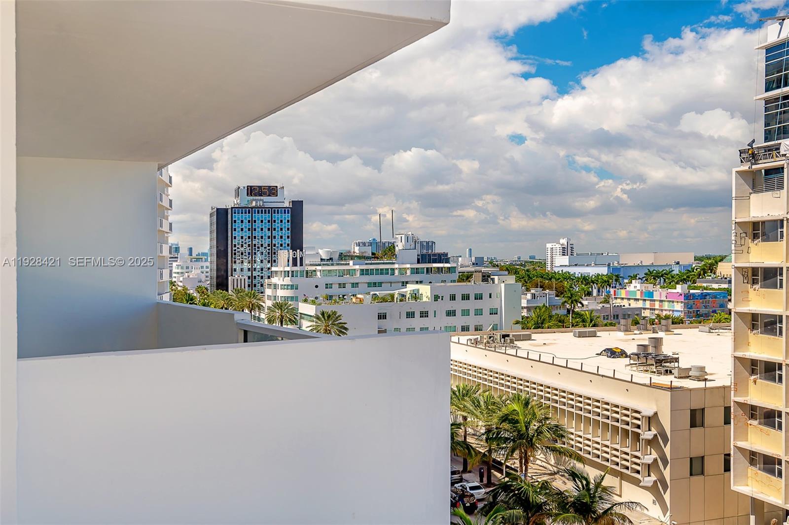 A view from a balcony overlooking a city skyline with buildings and palm trees — 100 Lincoln Rd # 839, Miami Beach FL 33139, MIAMI BEACH, FL