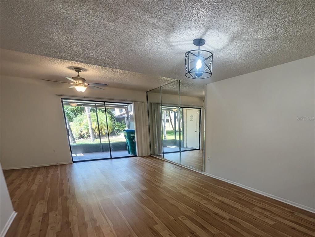 An aerial view shows a multi-unit residential complex situated along the shore of a lake — 9209 SEMINOLE BOULEVARD UNIT 67, SEMINOLE, FL