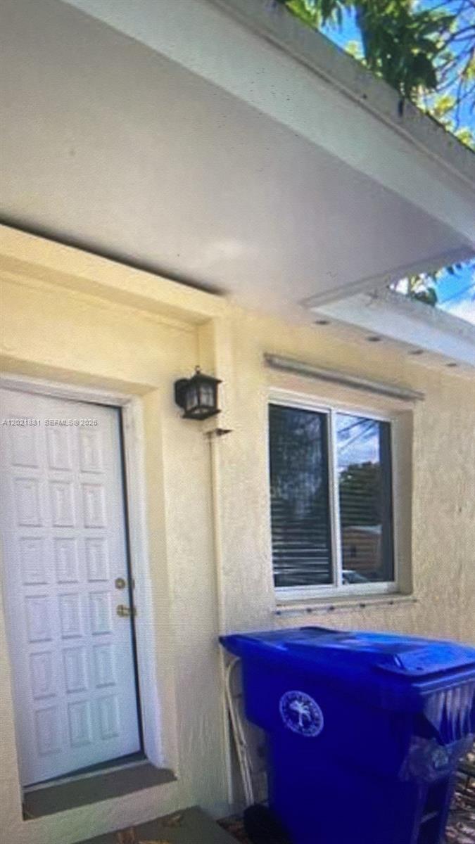 A white door and a window are on the exterior wall of a building — 7637 NW 3rd Ave, Miami FL 33150, MIAMI, FL