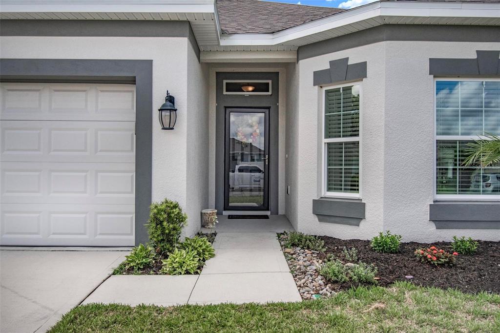 The exterior of a house features a garage, a front entrance, and two windows — 48 OAKLEAF WAY, PALM COAST, FL