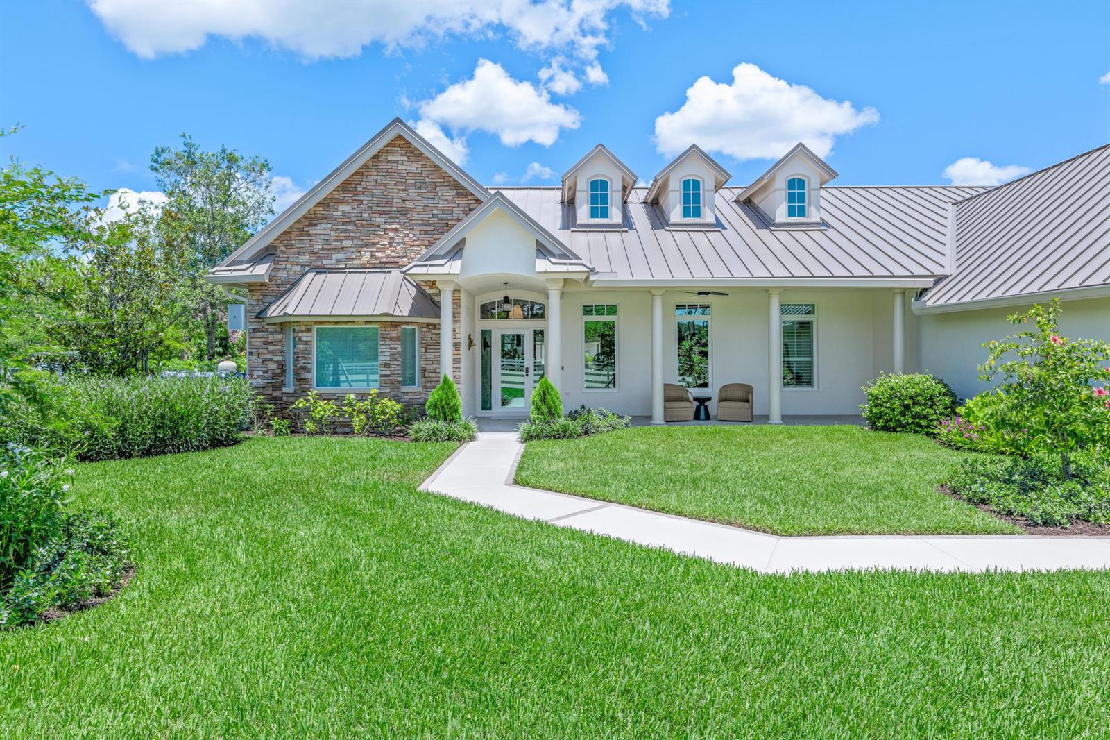 A single-story house with a stone facade, metal roof, and a front walkway — 1464 Stallion Drive, Loxahatchee FL 33470, LOXAHATCHEE, FL