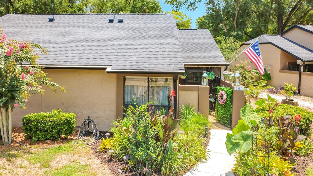 A tiered stone fountain stands in front of a sign for Village Townhomes — 940 DOUGLAS AVENUE UNIT 192, ALTAMONTE SPRINGS, FL