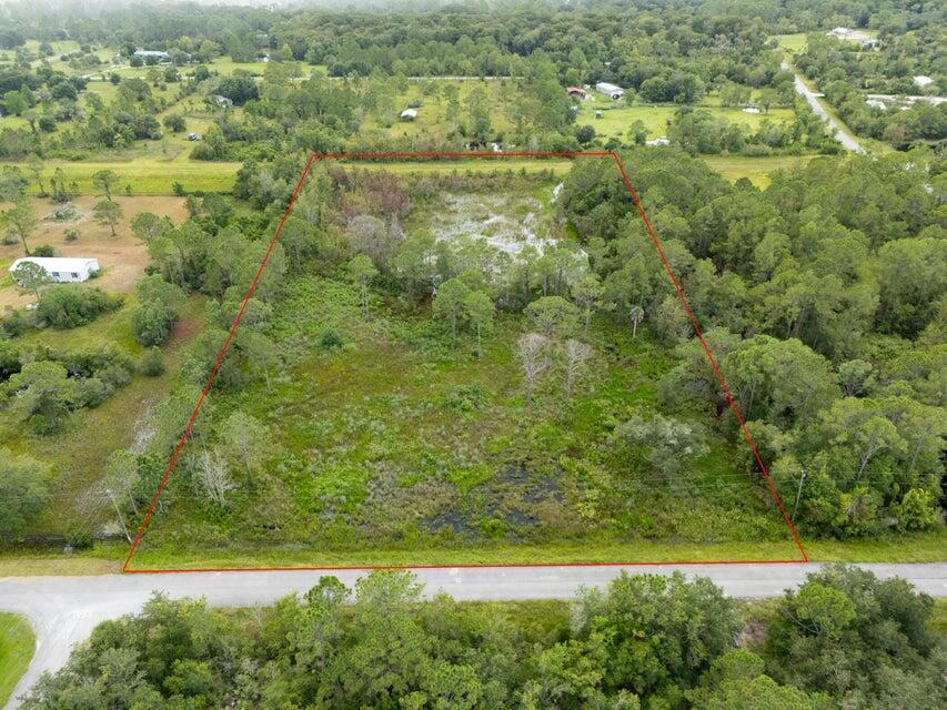 An aerial view shows a rectangular, wooded plot of land bordered by a paved road — 540 NE 365th Lane, Okeechobee FL 34972, OKEECHOBEE, FL
