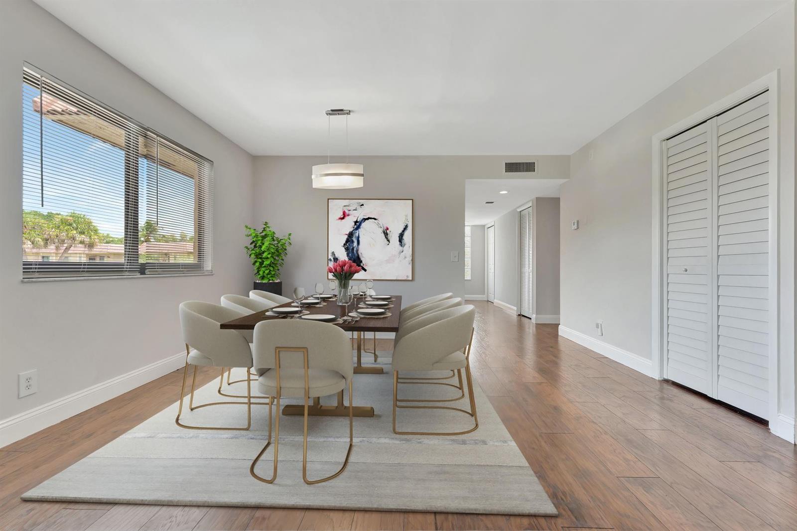 A living room with a sofa, coffee table, television, and sliding glass doors to a balcony — 334 Lakeview Drive # 204, Weston FL 33326, WESTON, FL