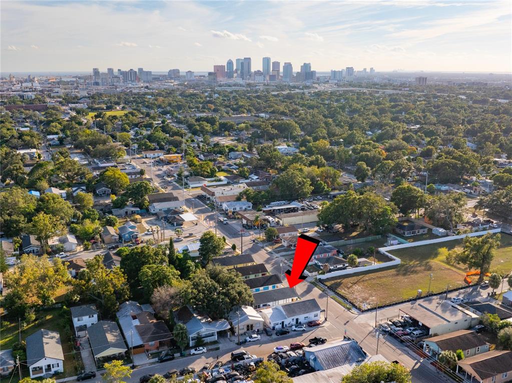 An aerial view shows a residential neighborhood with a red arrow pointing to a building — 3513 N 15TH STREET, TAMPA, FL