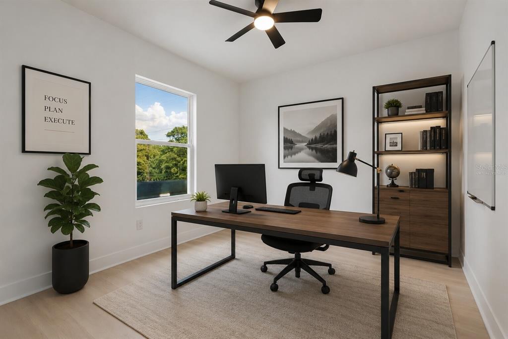 A home office features a wooden desk, an ergonomic chair, a bookshelf, and a window — 1070 E CHURCH STREET UNIT A, BARTOW, FL