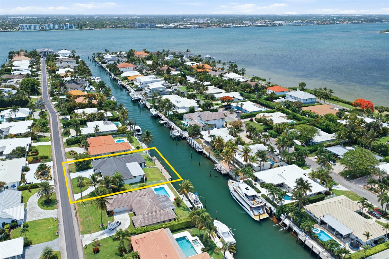 An aerial view shows a waterfront house with a yellow border along a canal — 1170 Fairview Lane, Singer Island FL 33404, SINGER ISLAND, FL