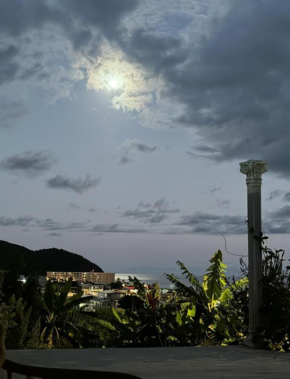 A view of a coastal town at night under a cloudy moonlit sky — 114 ROUTE 901 UNIT KM 2.0, MAUNABO, PR