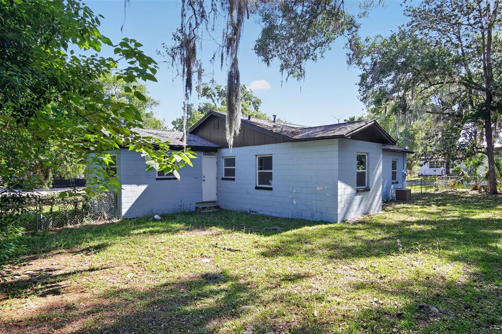 The exterior of a light blue concrete block house with a dark brown roof — 1308 SW 5TH STREET, OCALA, FL