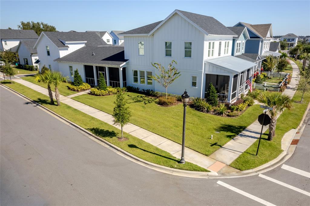 An aerial view shows a two-story white farmhouse-style home on a corner lot — 1101 EAGLES PASS WAY, WINTER GARDEN, FL