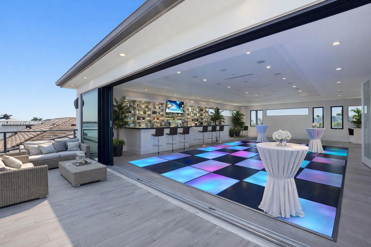 An indoor-outdoor event space features a bar, a glowing checkered dance floor, and patio seating — 5735 Riverside Dr, Cape Coral FL 33904, CAPE CORAL, FL