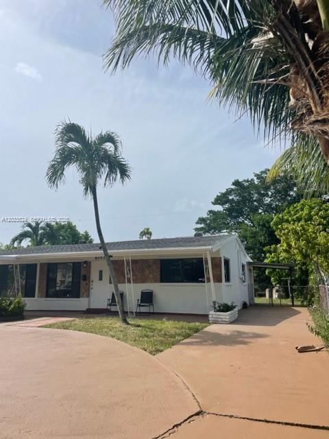 A single-story house with a palm tree in the front yard and a paved driveway — 6141 Wiley St, Hollywood FL 33023, HOLLYWOOD, FL