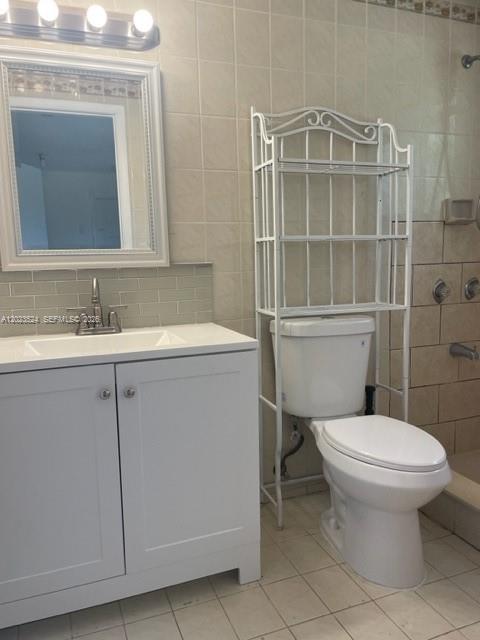 A bathroom features a white vanity with a sink, a mirror, and a toilet with shelving — 6141 Wiley St, Hollywood FL 33023, HOLLYWOOD, FL